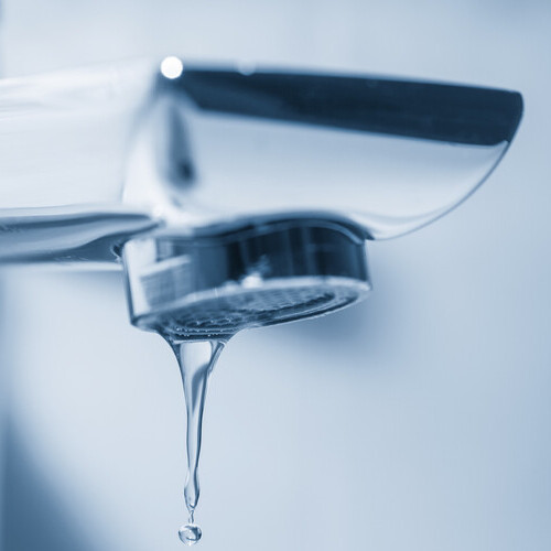 Tap and water drops on blue background